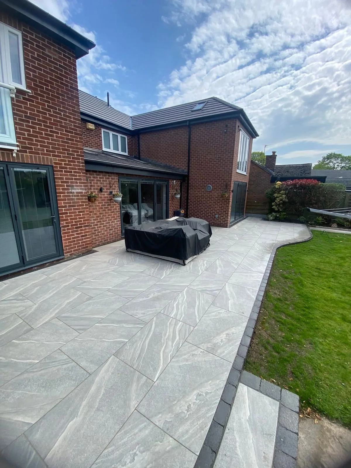 Grey porcelain patio and lawn